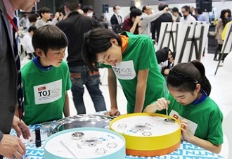 The TOJ kids trying to assemble bearings at the display area