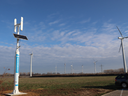 NTN Green Power Station (front) installed in NTN-AT and wind turbines facility of the electric power company