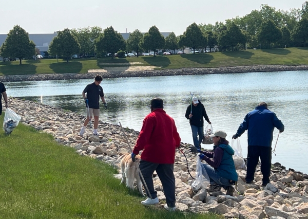 NTA PRECISION AXLE CORP. employees cleaning the pond 