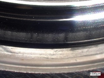 Photo:Raceway surface of outer ring after electrical pitting(developed product)