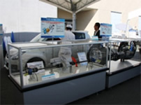 Photo: Exhibit of the One Motor EV Drive System (left) and the Steering System for Steer-by-Wire (right)