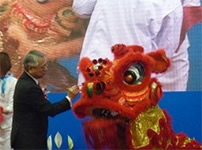 Photo: Director Takagi applying ink before a lion dance