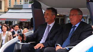 Annecy Mayor Jean Luc RIGAUT (left) and NTN-SNR Chairman Didier SEPULCHRE (right) test driving &ldquo;Q'mo&rdquo;